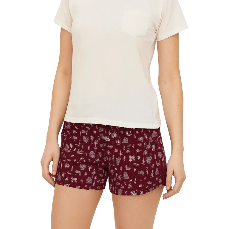 a woman wearing a white shirt and shorts