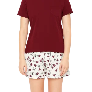 a woman wearing a red shirt and white shorts