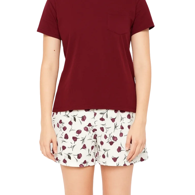 a woman wearing a red shirt and white shorts