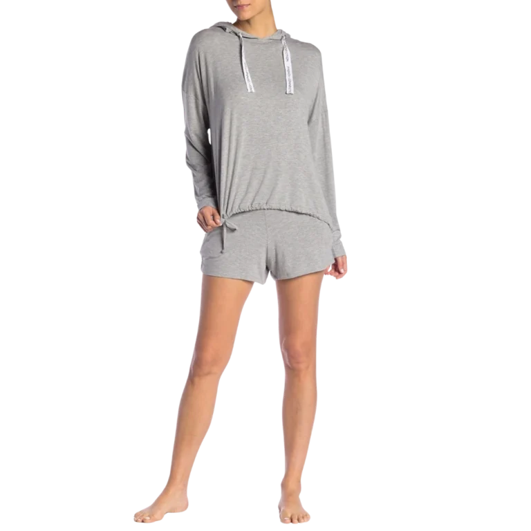 a woman in a grey shirt and shorts