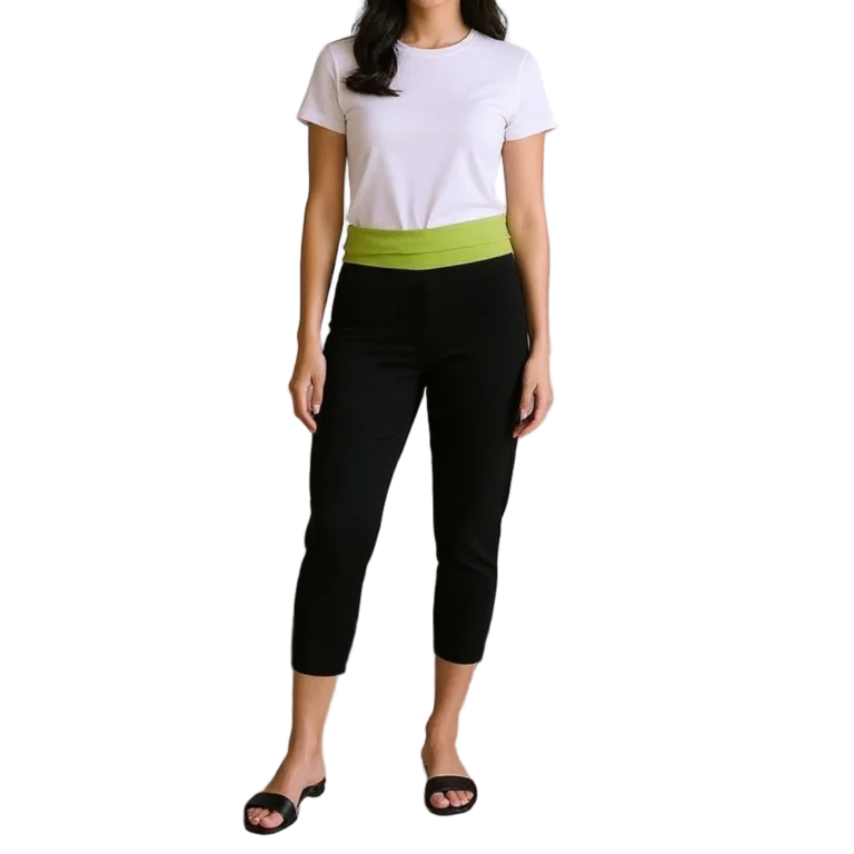 a woman standing in a white shirt and black pants